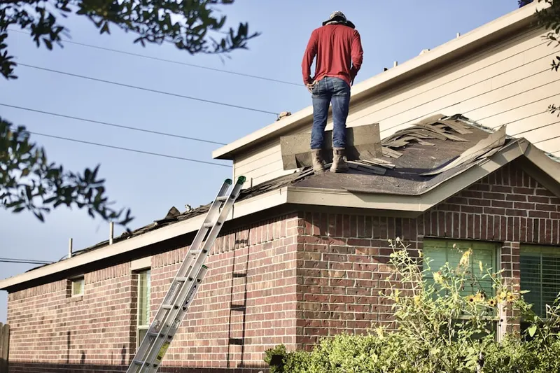 Professional roofer working on a residential roof in Home